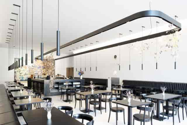 Modern PLATEFORME 10 restaurant with overhead lighting for corporate networking and brunch events.
