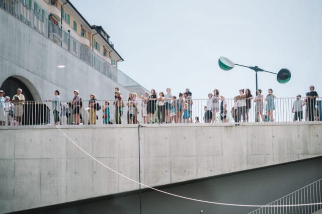 Event planner managing crowd flow at PLATEFORME 10 venue for outdoor event logistics.