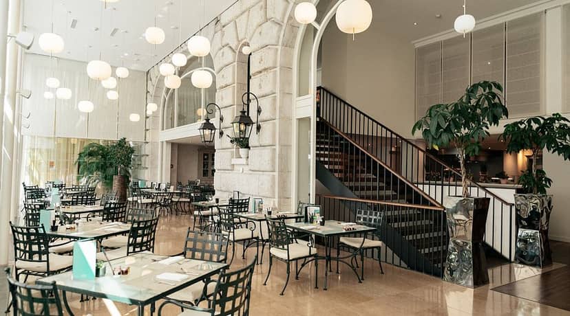 Upscale restaurant foyer with dramatic lighting for networking receptions and elegant banquets.