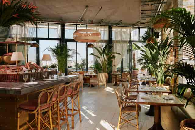 Elegant rooftop event space with large windows, perfect for networking and gatherings.