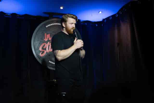 In Stitches Comedy club stage with pro audio for networking events and corporate breakout sessions.