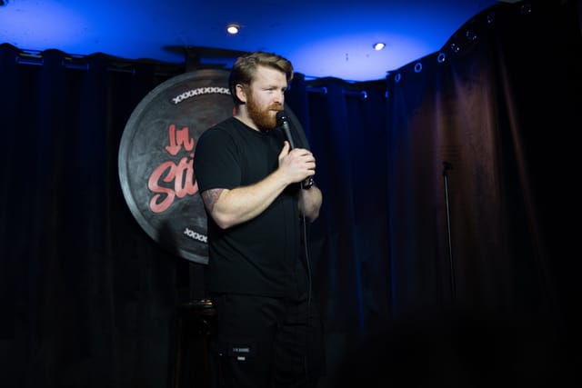 In Stitches Comedy club stage with pro audio for networking events and corporate breakout sessions.