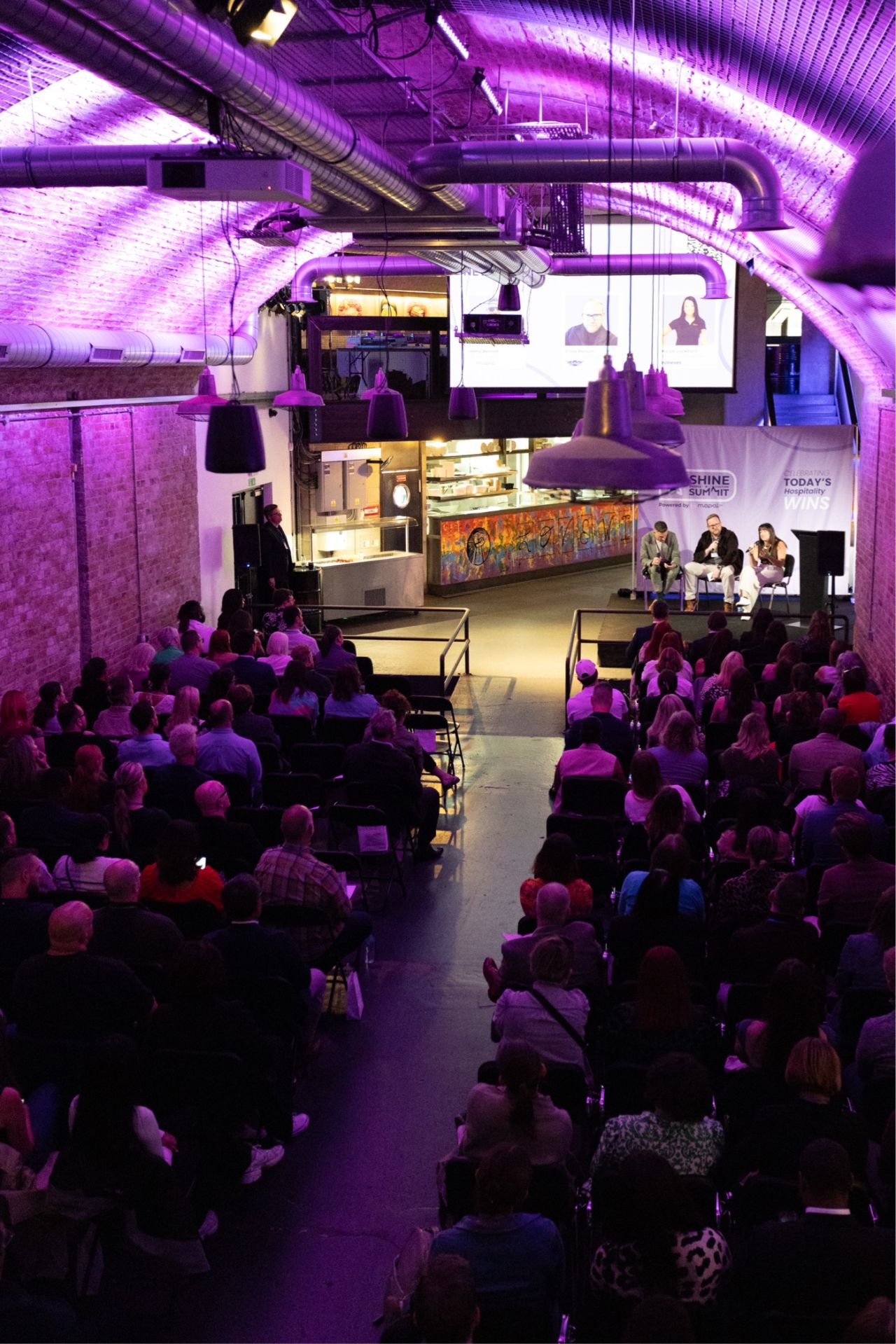 Panel discussion at Mamuśka Restaurant, vibrant lighting, networking event in Southbank.