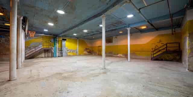 Industrial gymnasium event venue with columns for weddings and corporate galas.