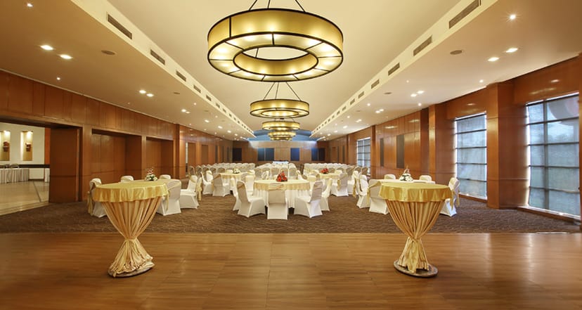 Maurya Banquets ballroom with wood-paneled walls, perfect for elegant wedding and corporate events.