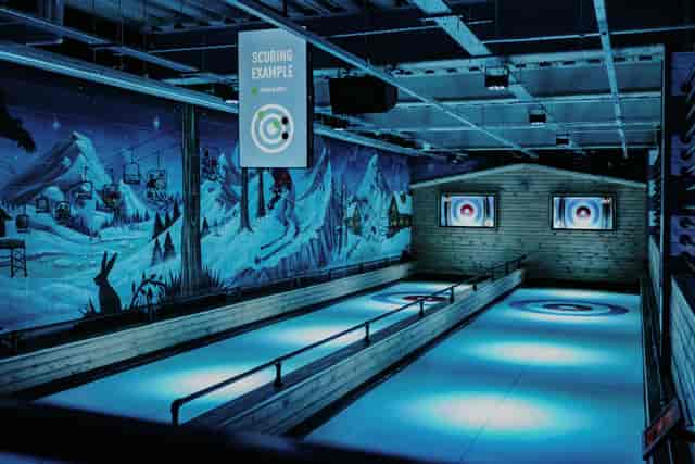 Indoor curling facility at The Lodge, vibrant mural for corporate events in Cheltenham.