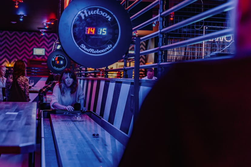 Roxy Lanes Tournament Area with shuffleboard, perfect for team-building and networking events.