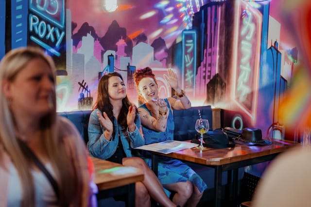 Karaoke Room at Roxy Lanes: vibrant neon atmosphere for social events and entertainment.