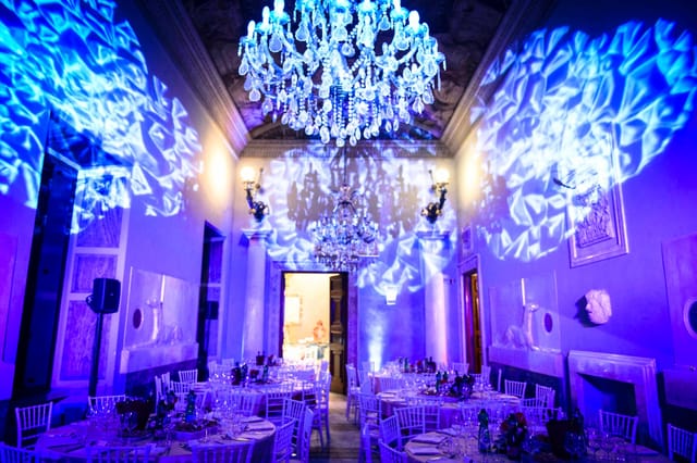 Sala Levrieri gala with blue uplighting and historic architecture for luxury events.