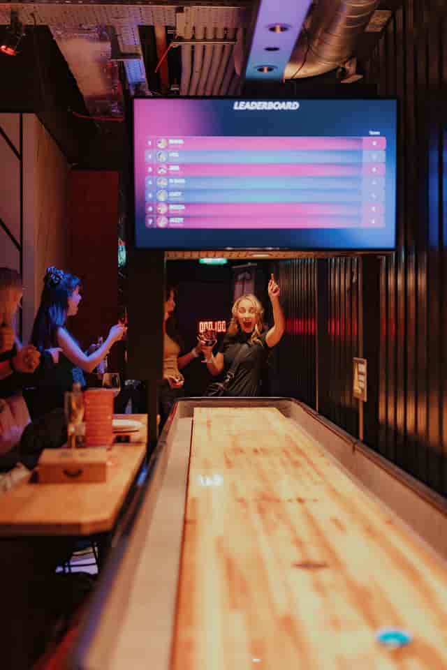 Engaging social event at Roxy Ball Room, St Mary Axe with shuffleboard and networking.