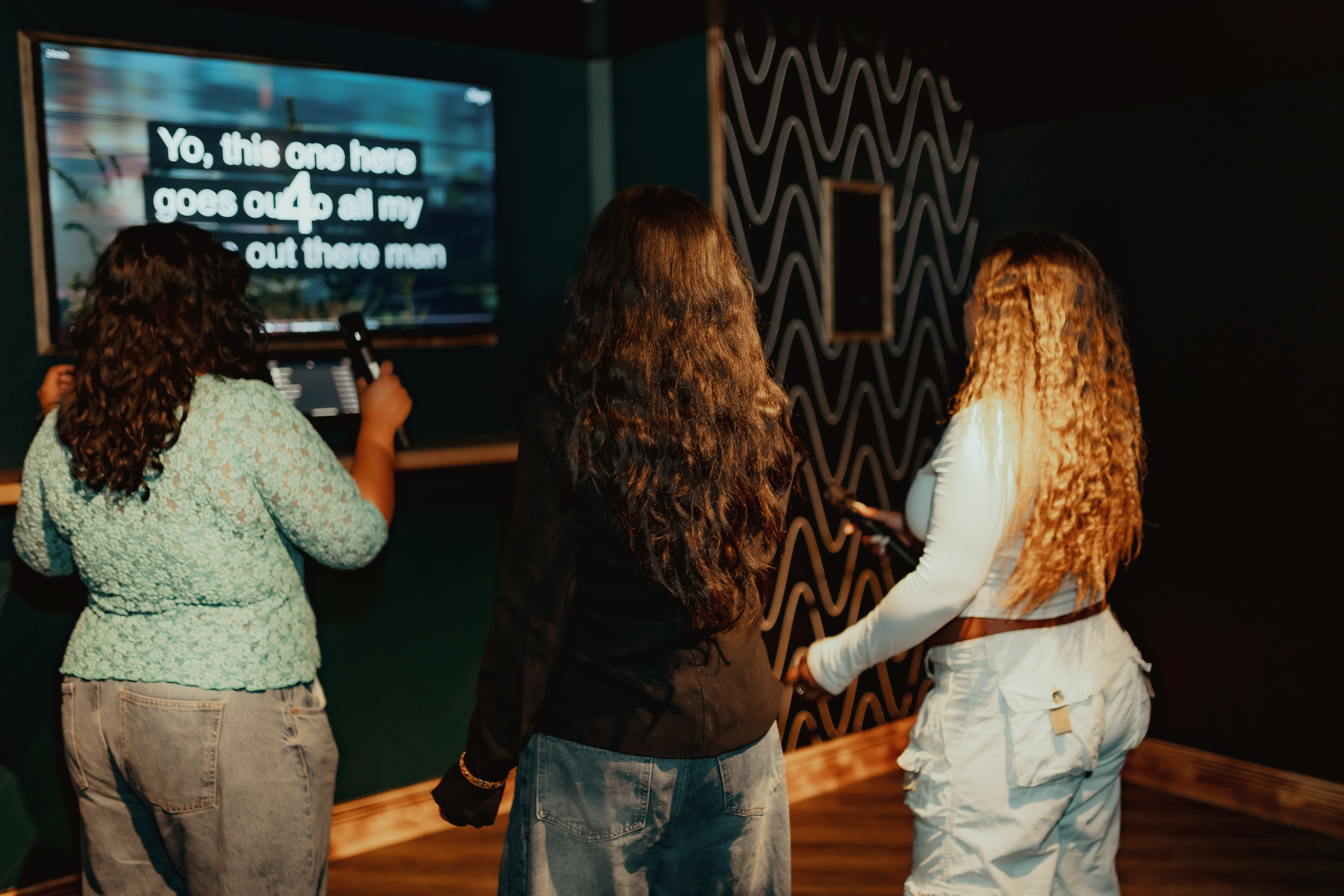 Karaoke room at Roxy Ball Room, London for team-building event with engaged attendees.