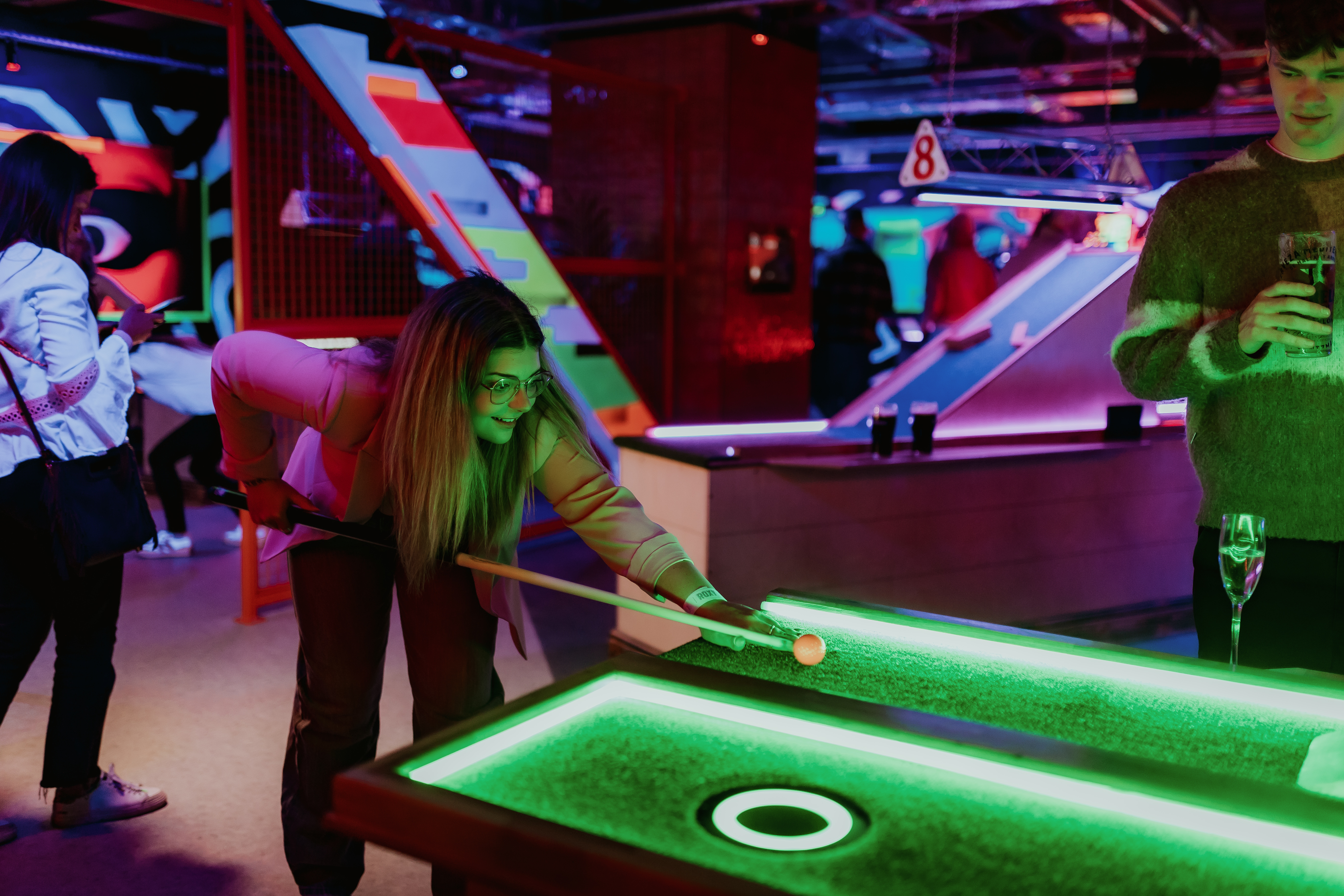 Vibrant event space with glowing pool table for team-building and social gatherings in London.