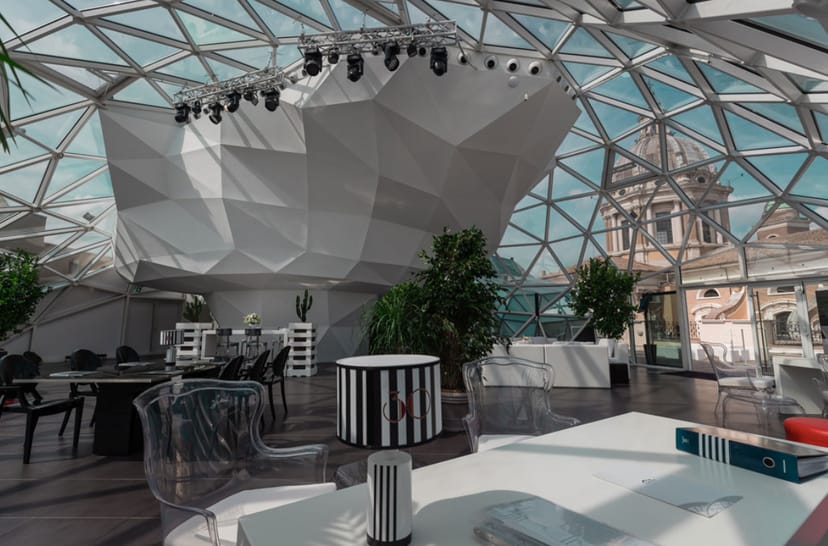 Modern event space with glass dome ceiling in La Lanterna Rome, ideal for meetings and gatherings.