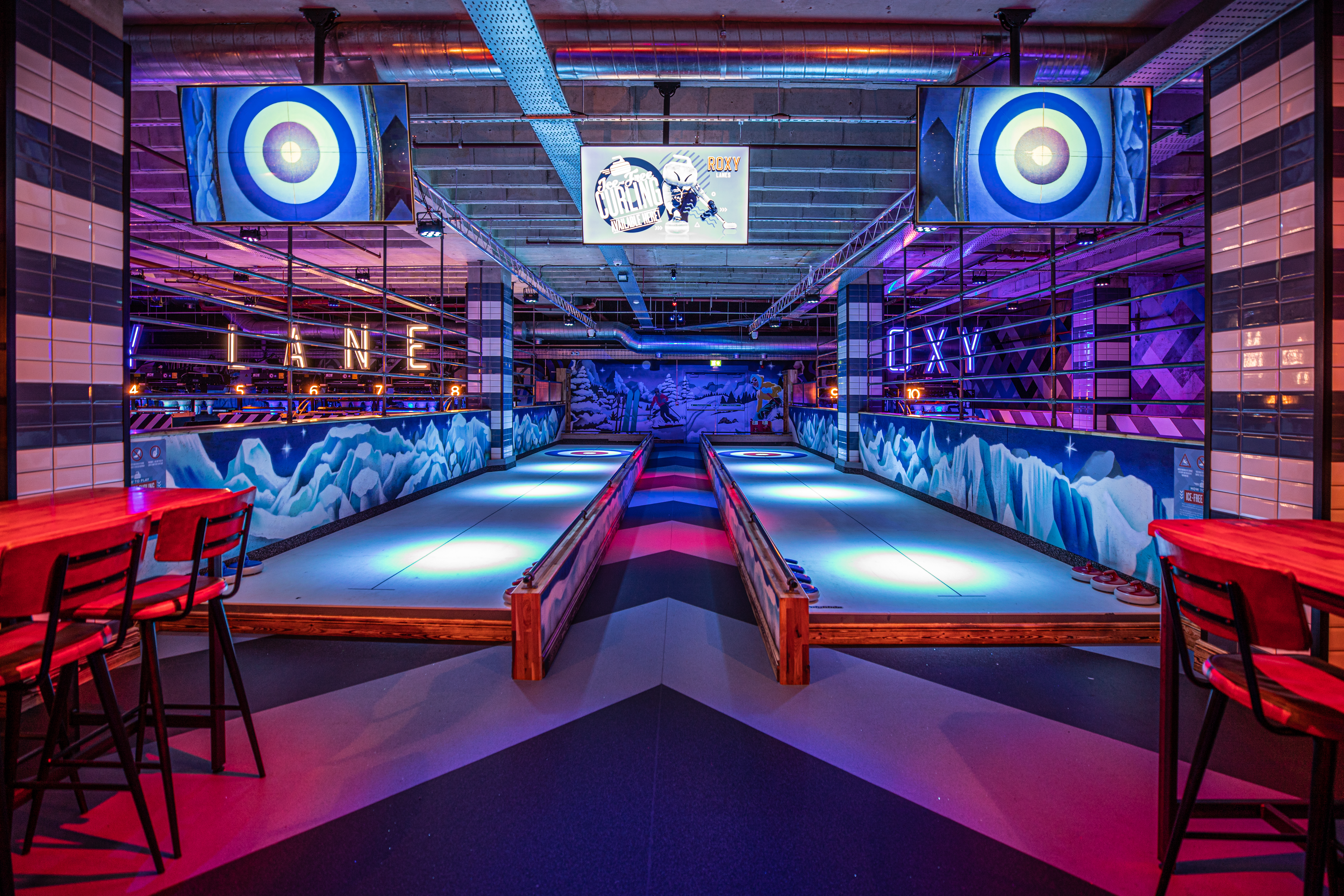 Modern event space at Roxy Lanes Leeds with illuminated bowling lanes for team-building.