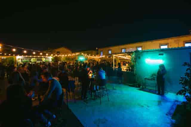 Outdoor evening reception on 1010 Hall rooftop with bistro lighting for corporate event or party.