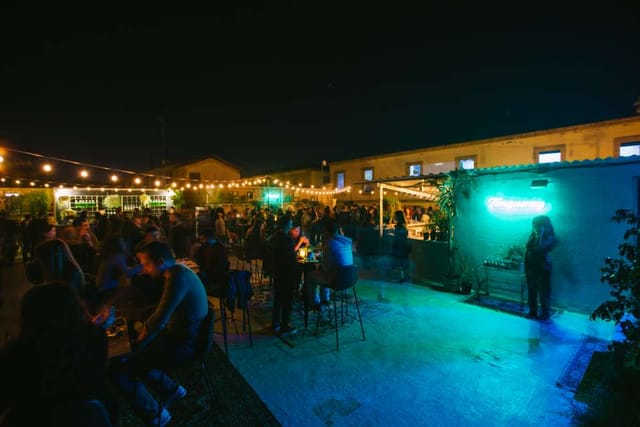 Outdoor evening reception on 1010 Hall rooftop with bistro lighting for corporate event or party.