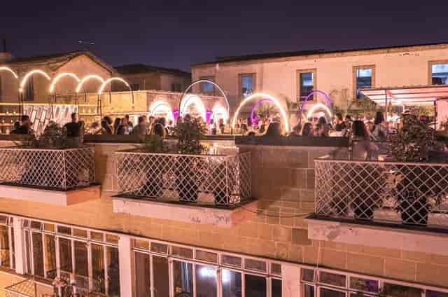 Rooftop event space at 1010 Hall with neon lighting, perfect for evening receptions and social events.