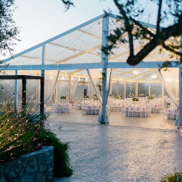 Clear-span tent wedding at Lapatsa Countryside Venue featuring elegant white drapery for upscale galas.