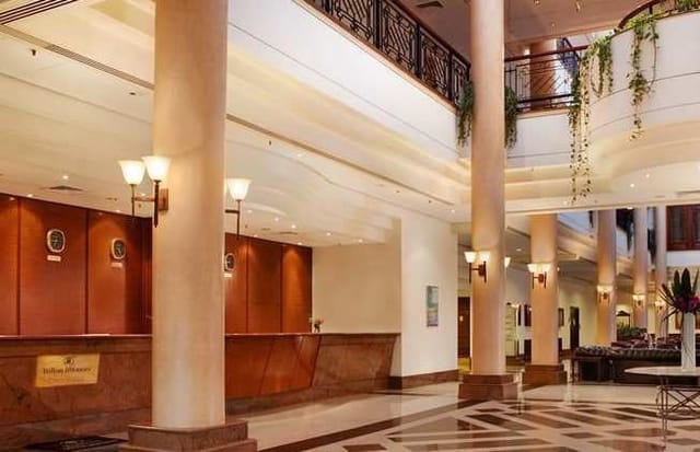 Spacious Hilton Nicosia hotel lobby with high ceilings for event registration and receptions.