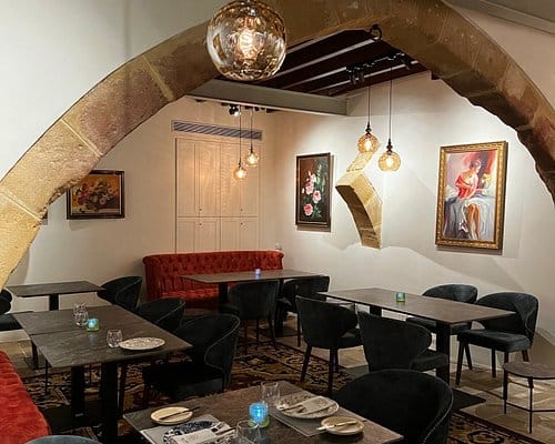 Historic stone restaurant with plush velvet seating for private VIP dinners and breakout sessions.