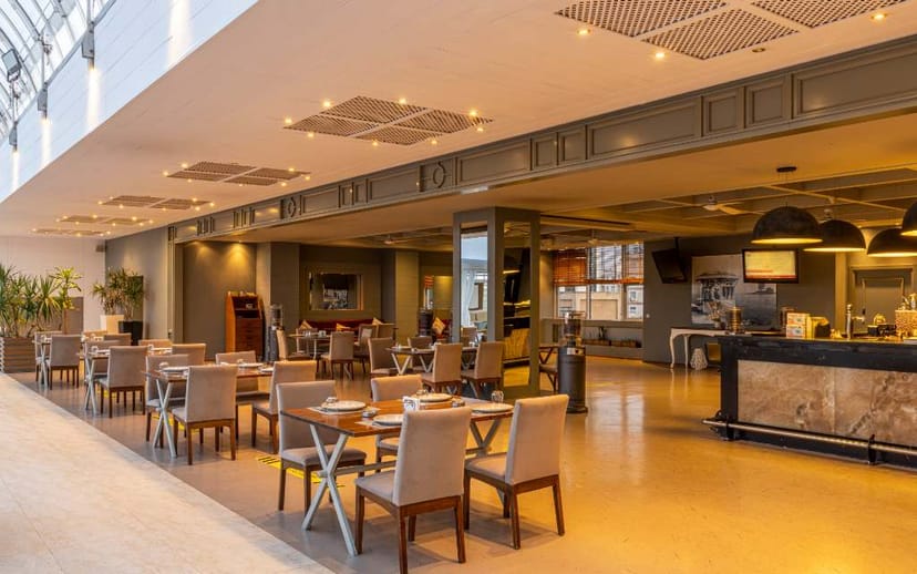 Grand Pasha Lefkosa breakout area with modular tables and bar for corporate meetings and receptions.