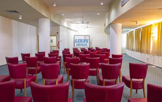 Conference room theater setup with pillars at Louis Imperial Beach Hotel for business meetings.