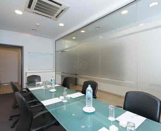 Boardroom meeting room with glass-top table at The Classic Hotel Nicosia for business conferences.
