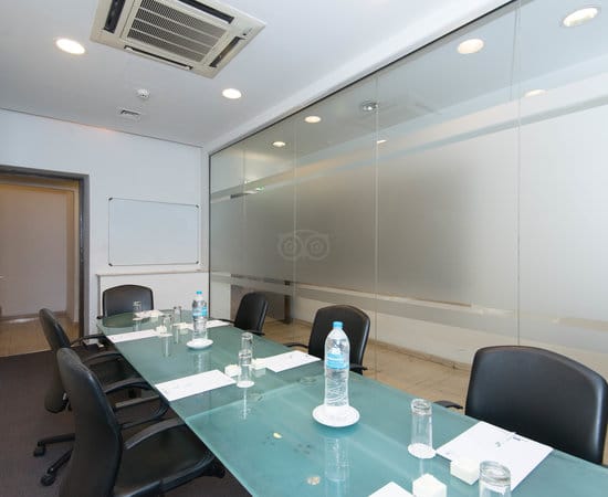 Boardroom meeting room with glass-top table at The Classic Hotel Nicosia for business conferences.