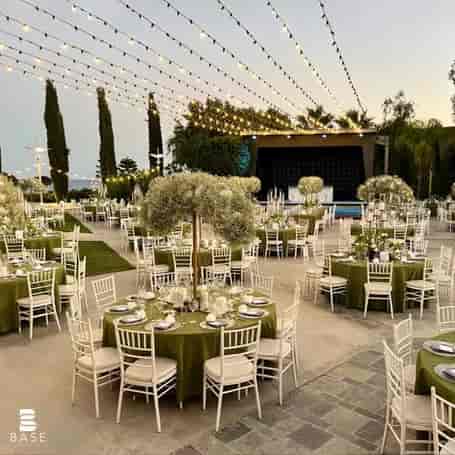 Outdoor evening wedding reception at BASE Events with baby's breath centerpieces and string lighting.