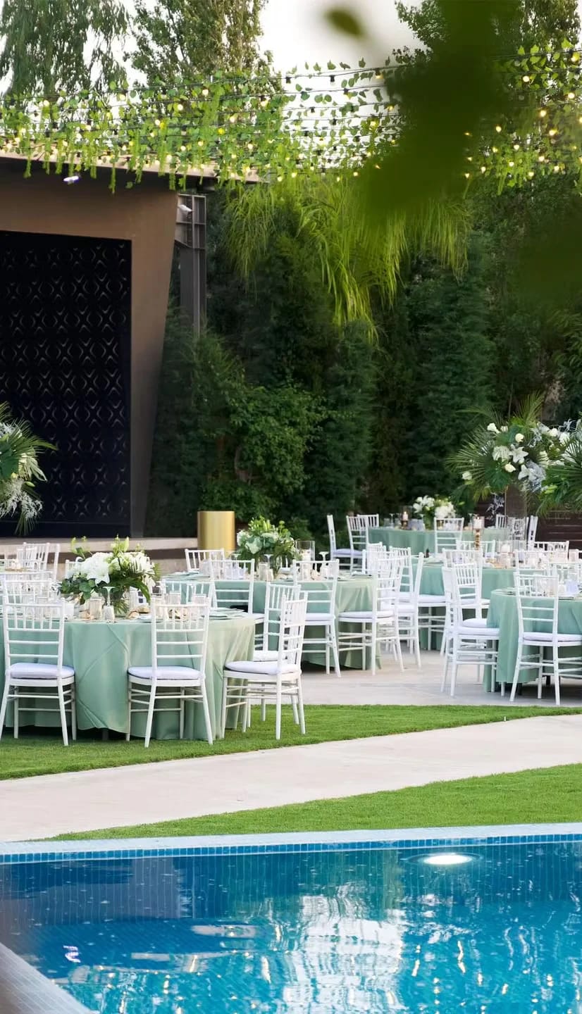 Outdoor garden ceremony area with sage decor, perfect for upscale weddings and corporate galas.