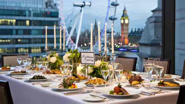 Premium catering setup with London skyline view for corporate gala or VIP dinner.