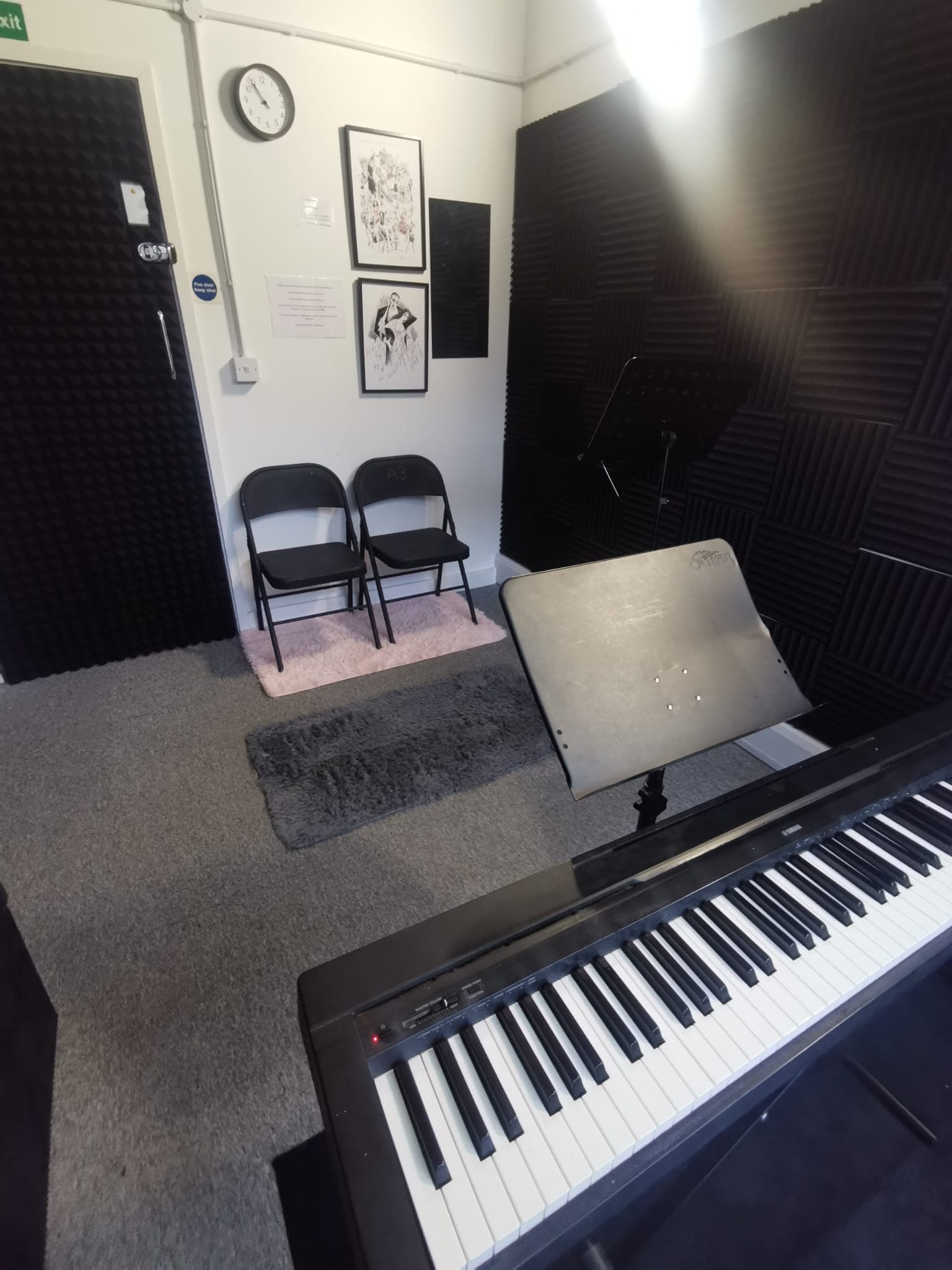 Small soundproof studio with acoustic paneling for intimate events and performances.