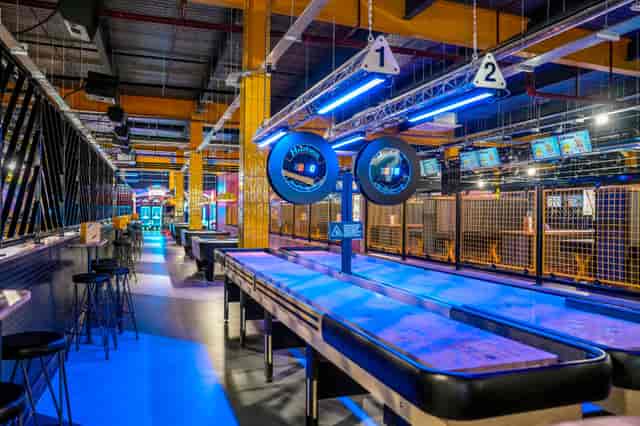 Vibrant shuffleboard venue for social events in King Pins Leeds White Rose Centre.