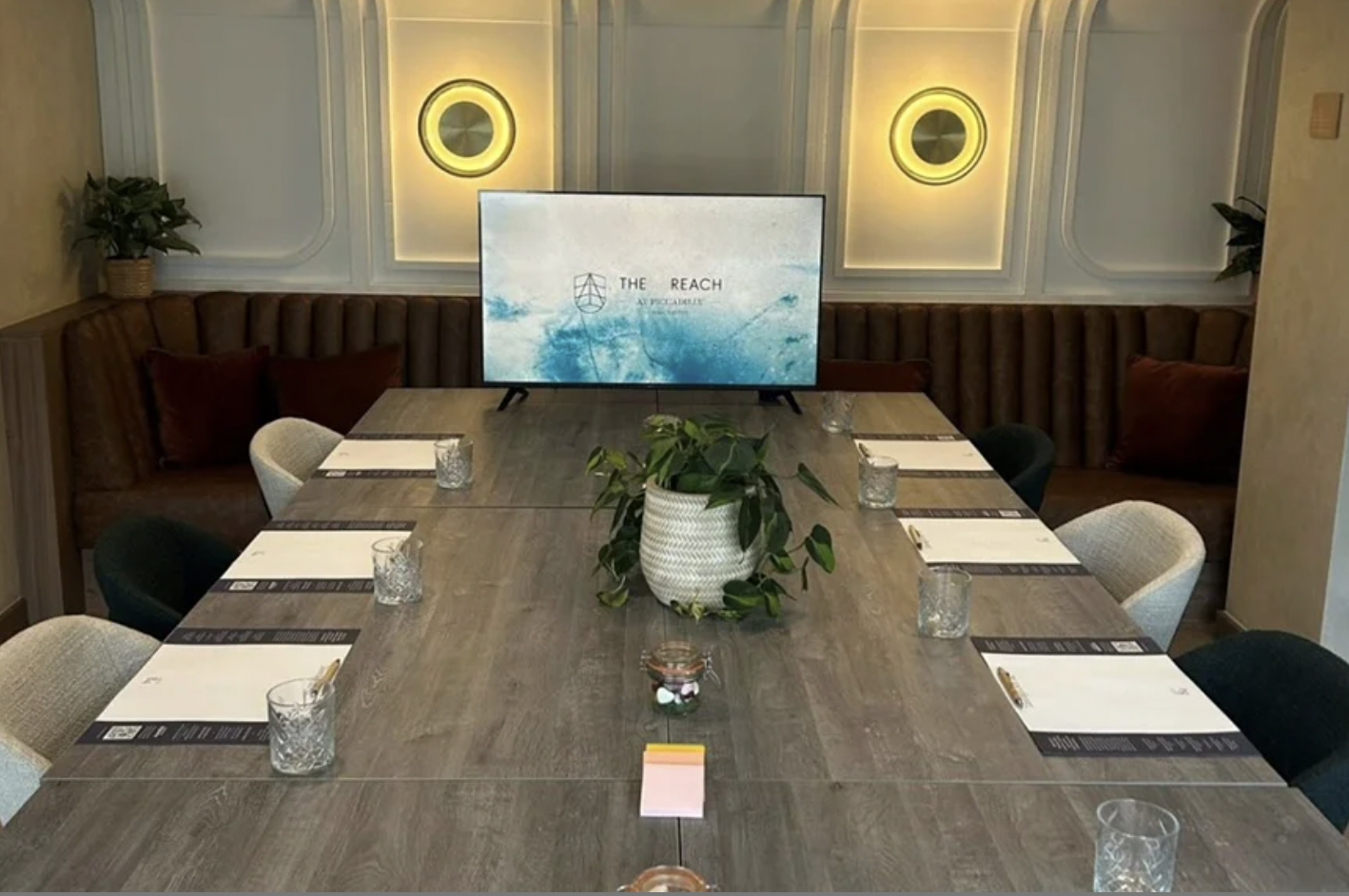 "Meet@Lock84 meeting room with elegant table settings and greenery in Manchester for business events."