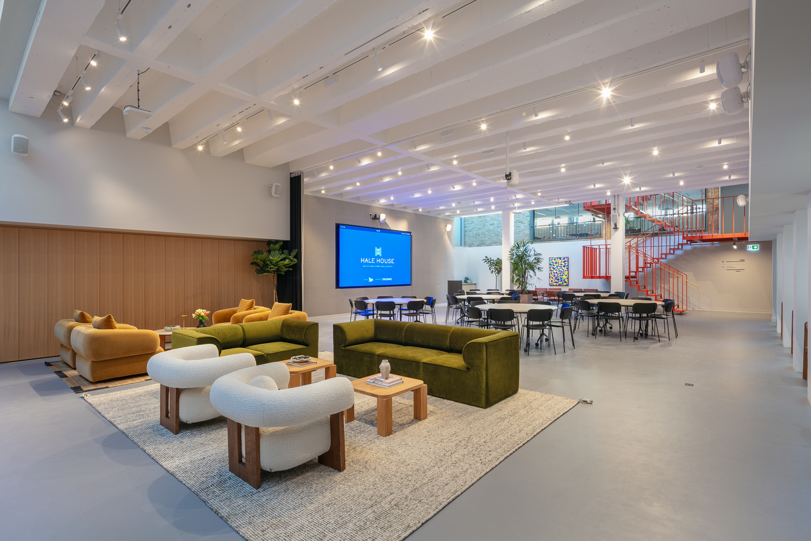 Corporate event lounge at Hale House with AV wall for networking and breakout sessions. - Banner