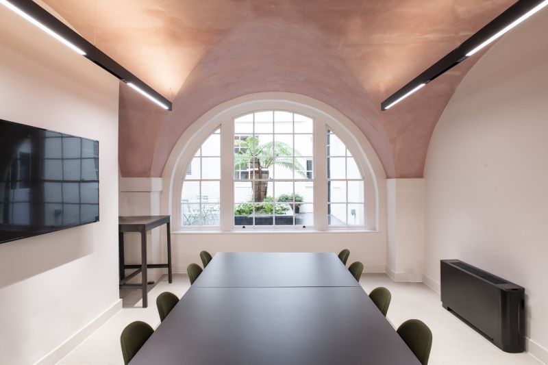 Modern meeting room with black table and green chairs at British Veterinary Association.