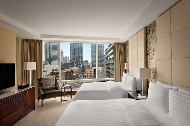 Premier one-bedroom hotel suite with floor-to-ceiling windows for conference accommodation.