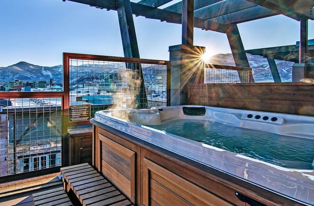 Luxury rooftop suite with mountain views for VIP incentive retreats and upscale aprés-ski events.