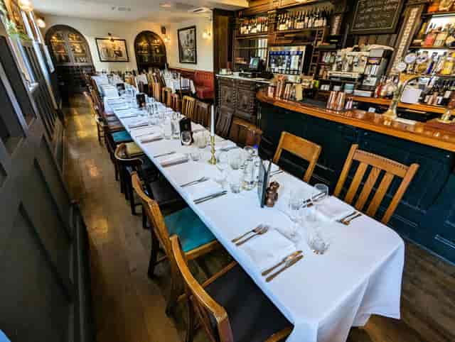 Elegant dining room with long table, perfect for corporate dinners or intimate gatherings.