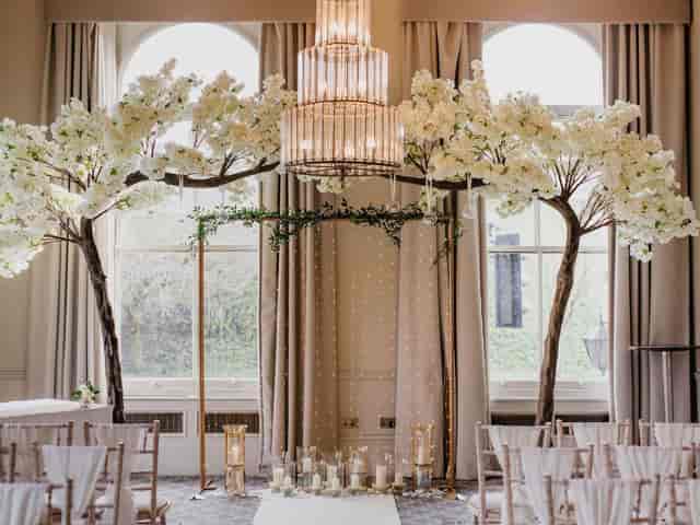 Elegant wedding venue with floral archway and chandelier ambiance in The Milner York.