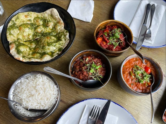 Family-style lunch spread at Mala Indian Kitchen & Bar terrace for corporate dining events.