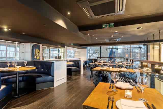 Mala Indian Kitchen & Bar interior, booth seating, upscale corporate event venue, networking space.