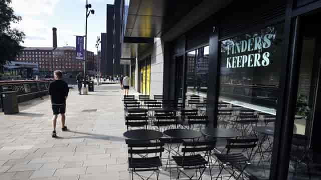 Outdoor networking hub bar setup on urban promenade for corporate event breakout space.