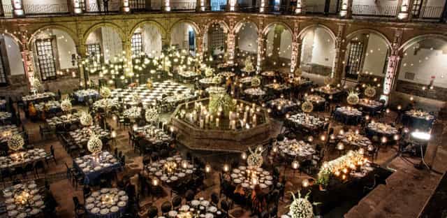 Gala dinner at Ex Convento San Hipolito featuring dramatic string lighting and historic courtyard.
