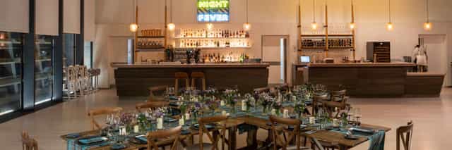 V&A Dundee Upper Foyer: rustic-chic venue with neon bar for corporate mixers and receptions.