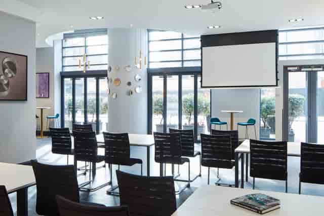 Bright meeting room at London Marriott Maida Vale with classroom setup for corporate training.