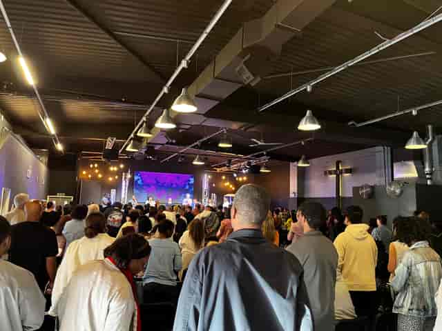 Packed conference hall with engaged attendees at Victory Outreach Manchester.