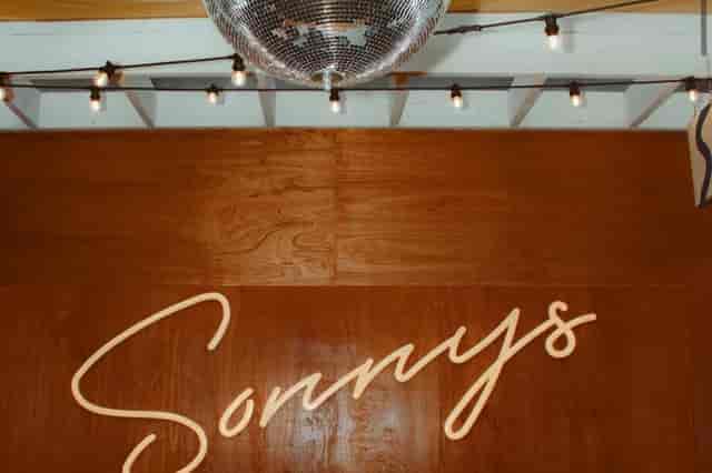 Neon-lit wood feature wall at Sonnys Riviera rooftop bar for private event venue photography.