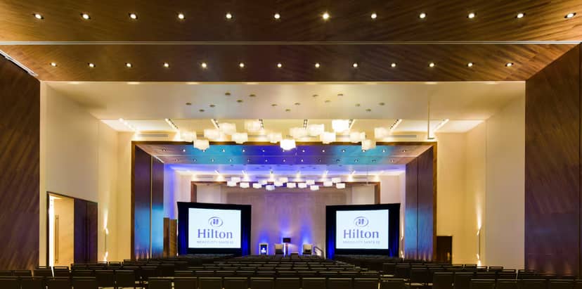 Hilton Santa Fe ballroom with dual screens for corporate presentations and professional events.
