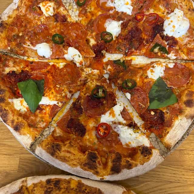 Artisanal pizza at Pecorino Restaurant, perfect for casual catering and corporate event breaks.